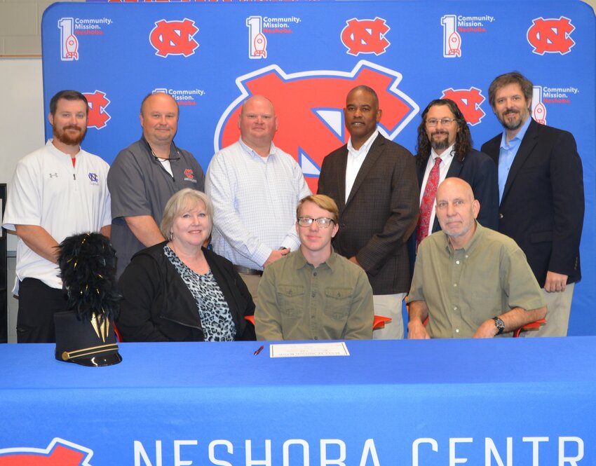 Neshoba Central’s Spencer Benson signed with East Central Community College to further his education and be a member of the Wall O’ Sound Band. Pictured, front from left, are his mother Donna Benson, Spencer Benson, and his father Douglas Benson (Back) Assistant Principal Jonathan Walker,  Principal Jason Gentry, Assistant Principal Brent Pouncy Assistant Principal LaShon Horne, Band Director Daniel Wade,  and ECCC Representative Justin Sharp.